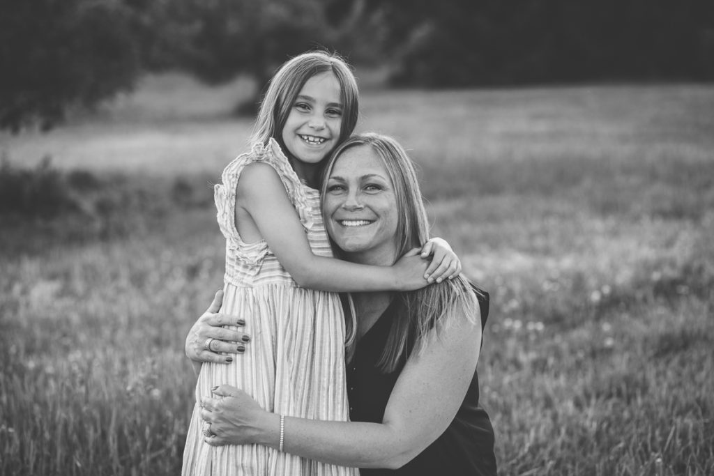 girl in stripped dress hugging mom Clifton Park NY