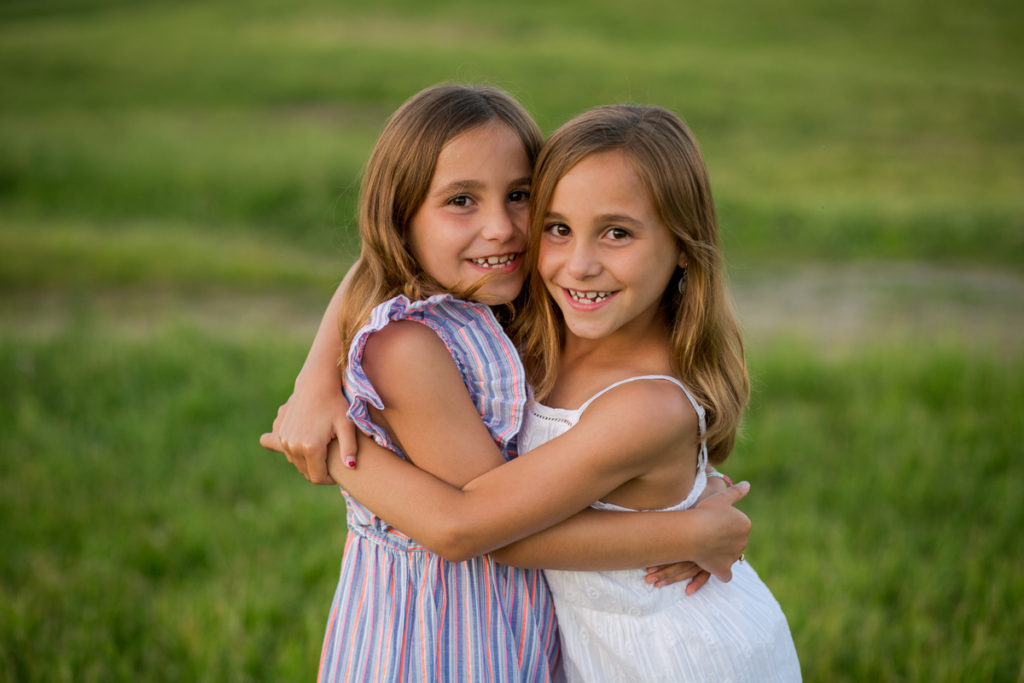 twin sisters hugging