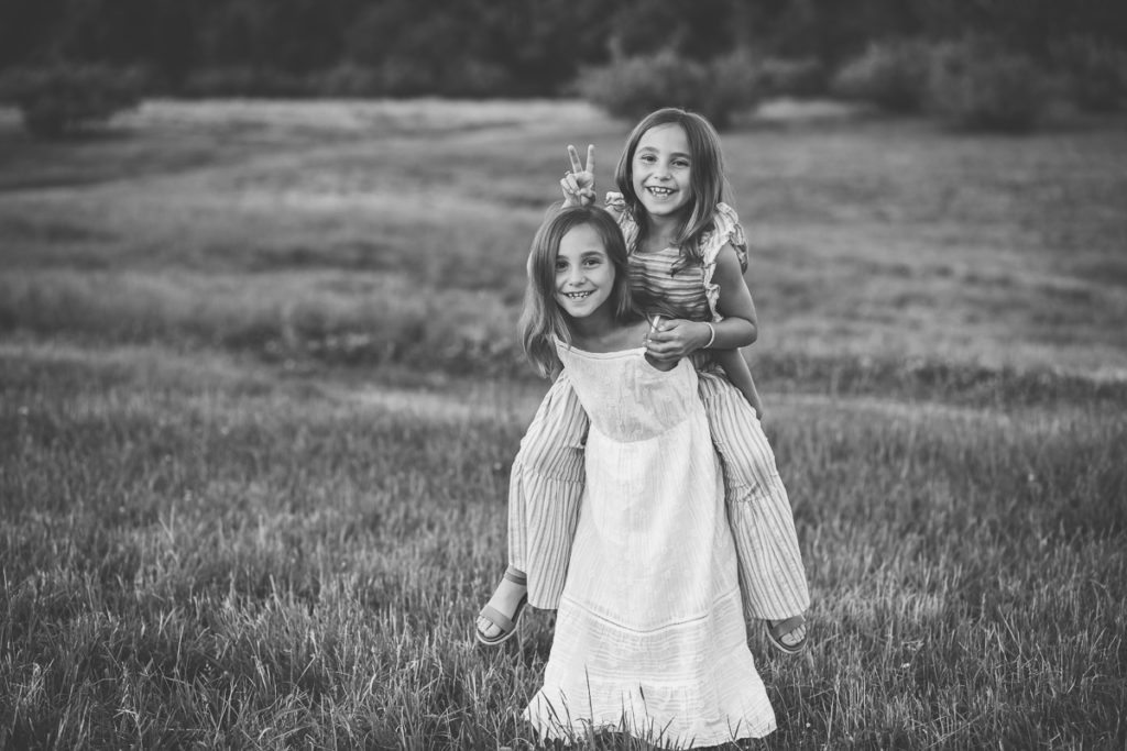 sister twins giving a piggy back Clifton Park NY