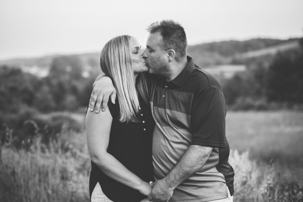 husband and wife kissing black and white portrait