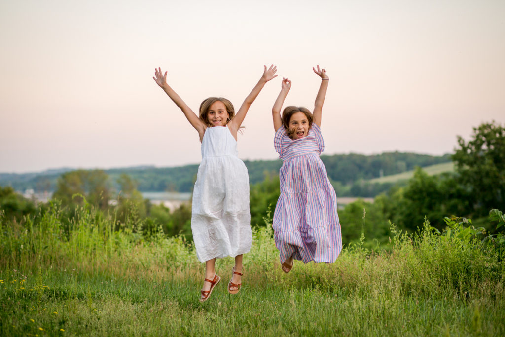 twin girls jumping for joy Clifton Park NY
