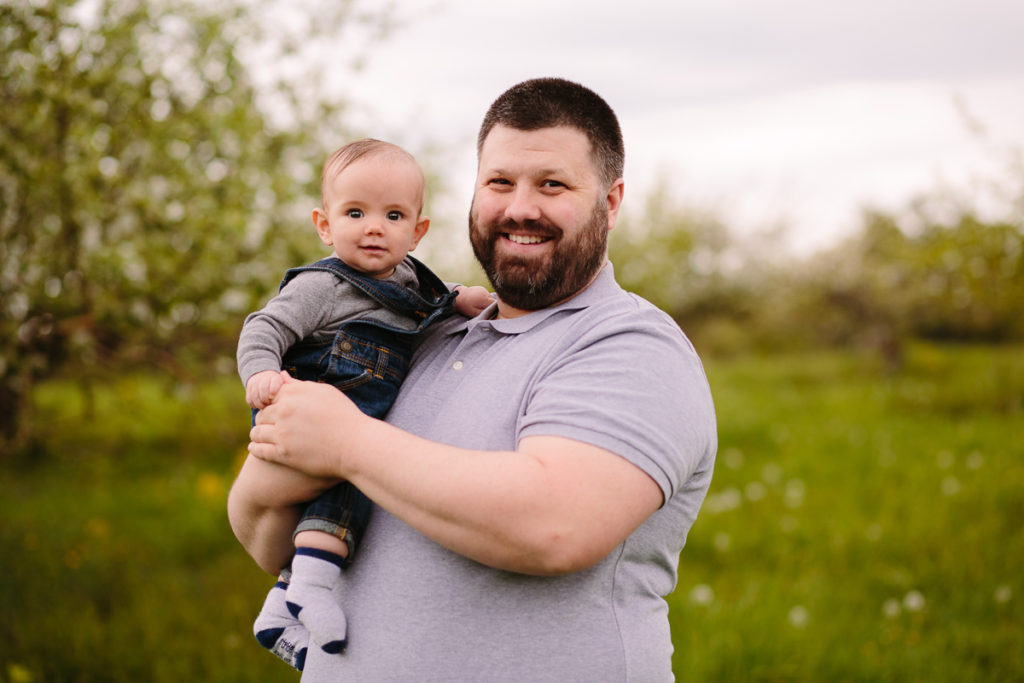 dad holding baby boy in overalls clifton park ny