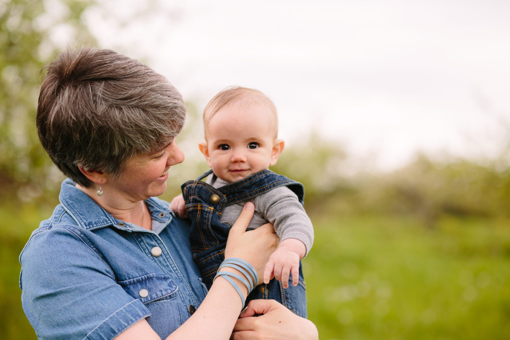 mom holding baby boy in overalls Clifton Park NY baby photographer