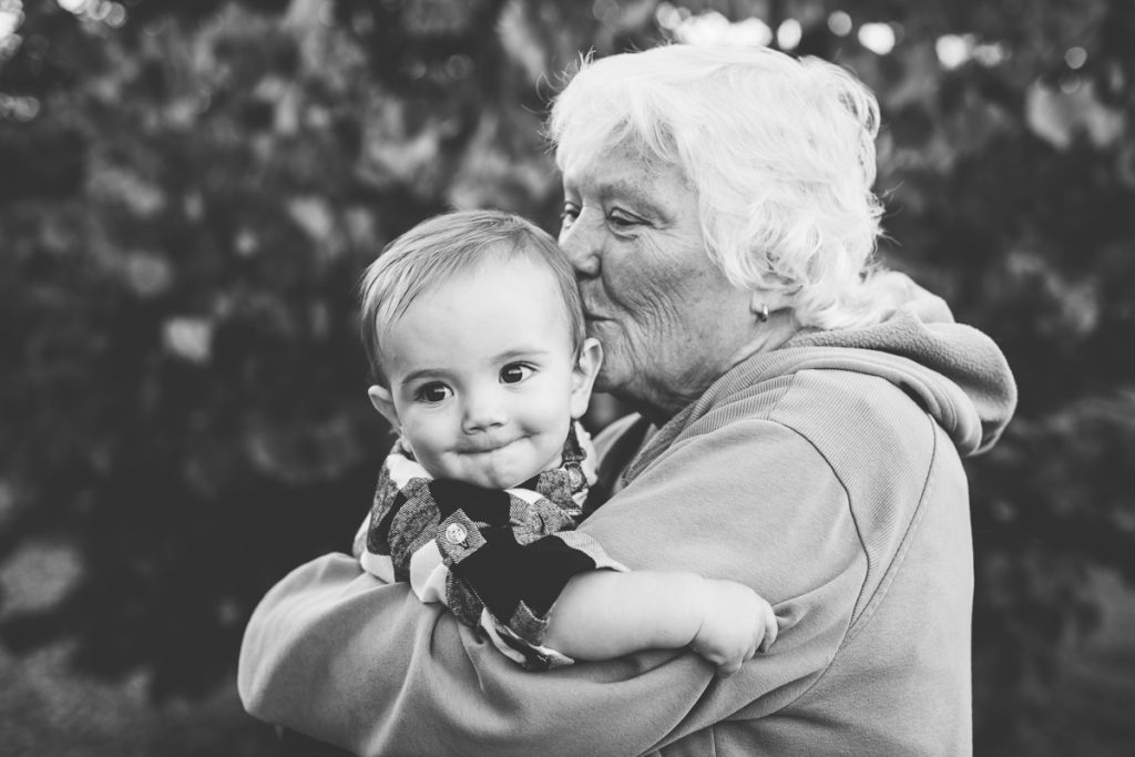 grandma kissing grandsons cheek black and white