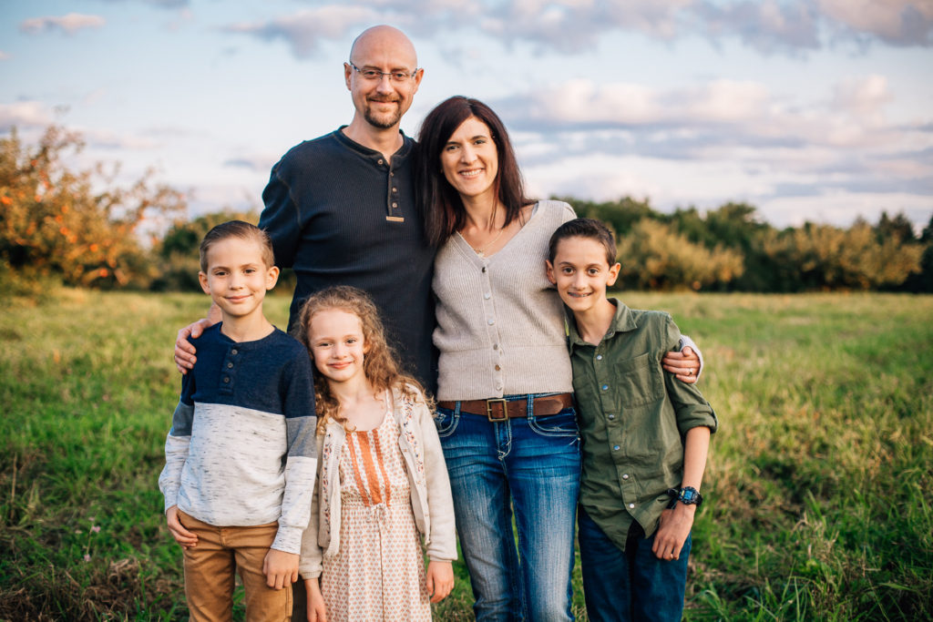 mom and dad with three kids at Riverview Orchards 