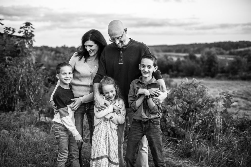 family of 5 laughing together outside