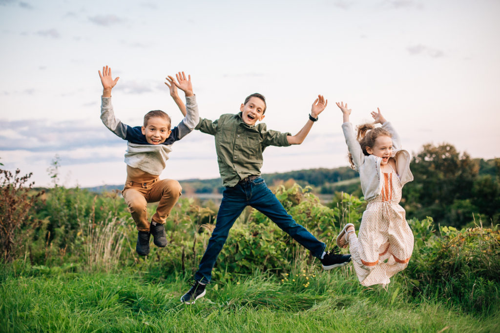 three kids jumping in the air
