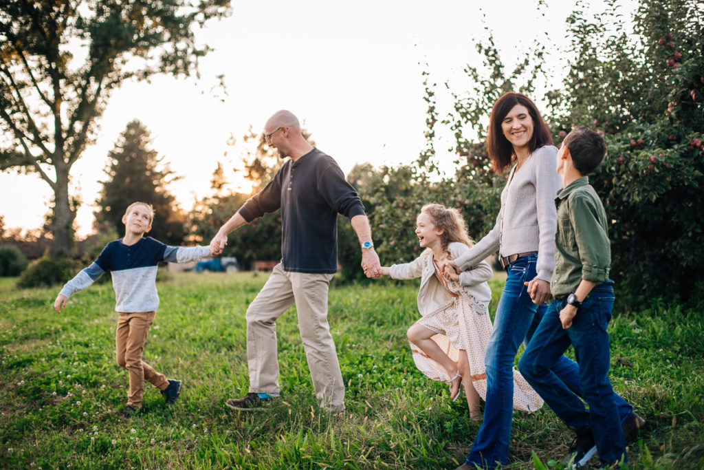family of 5 walking around apple orchard Clifton Park NY