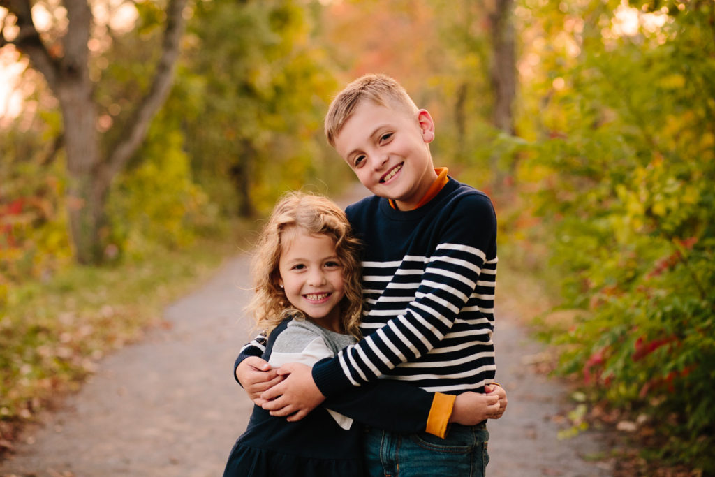Kids hugging during the fall in Clifton Park NY Photographer