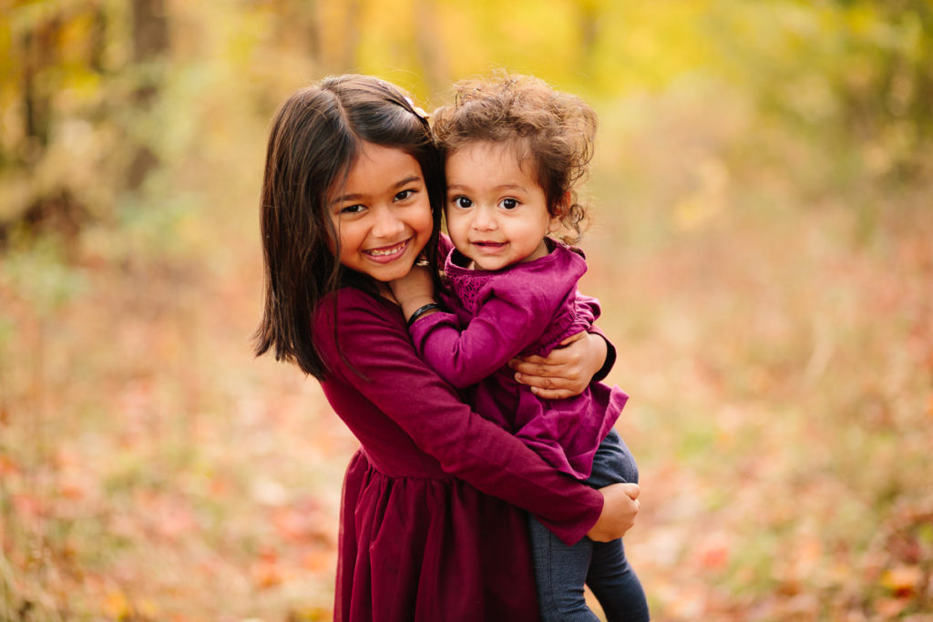 big sister holding baby sister Family photographer