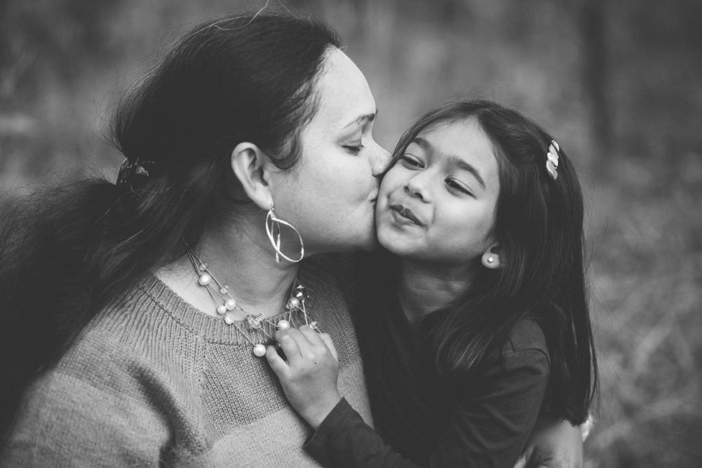 mom kissing daughter on cheek Saratoga NY