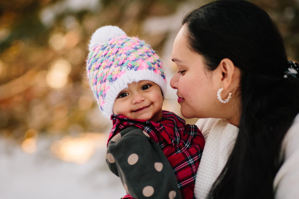 mom kissing baby face wearing winter hat Saratoga NY