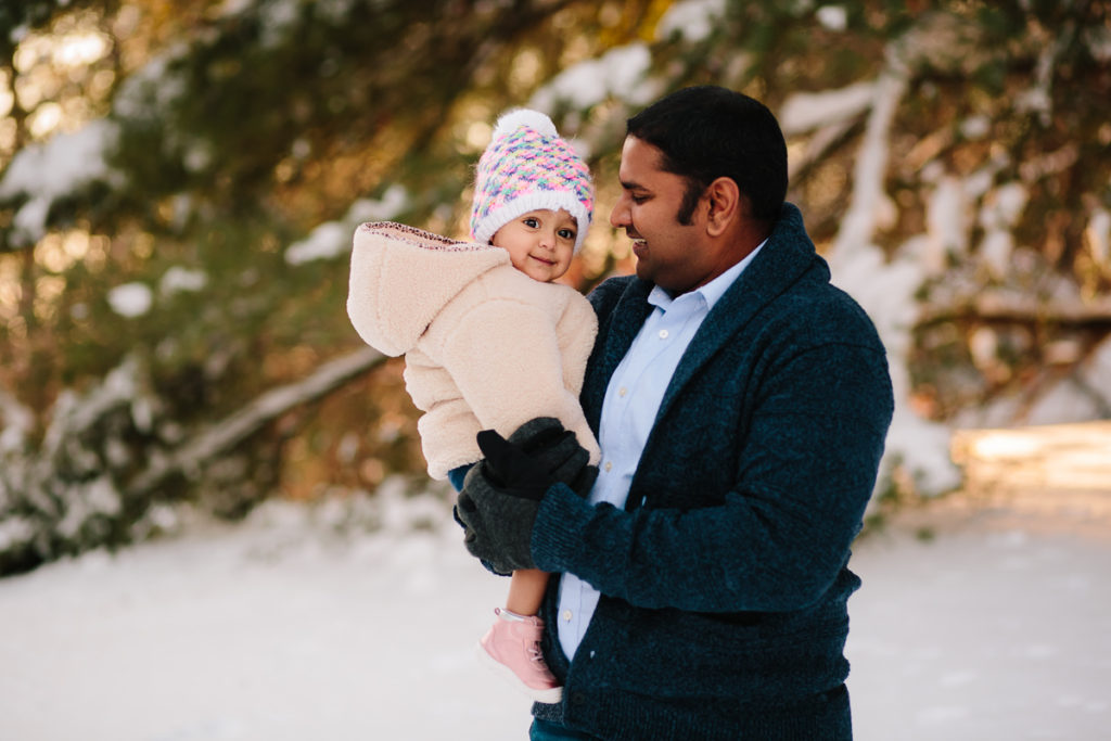dad holding baby in the snow Saratoga NY
