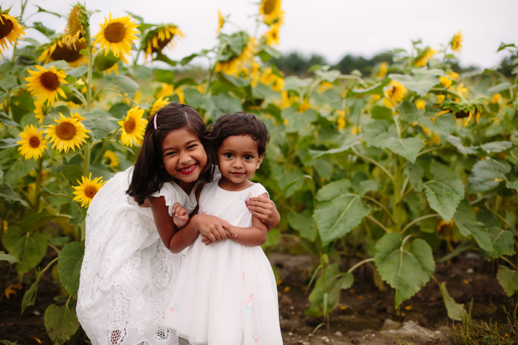 sisters in sunflower field Saratoga NY family photographer